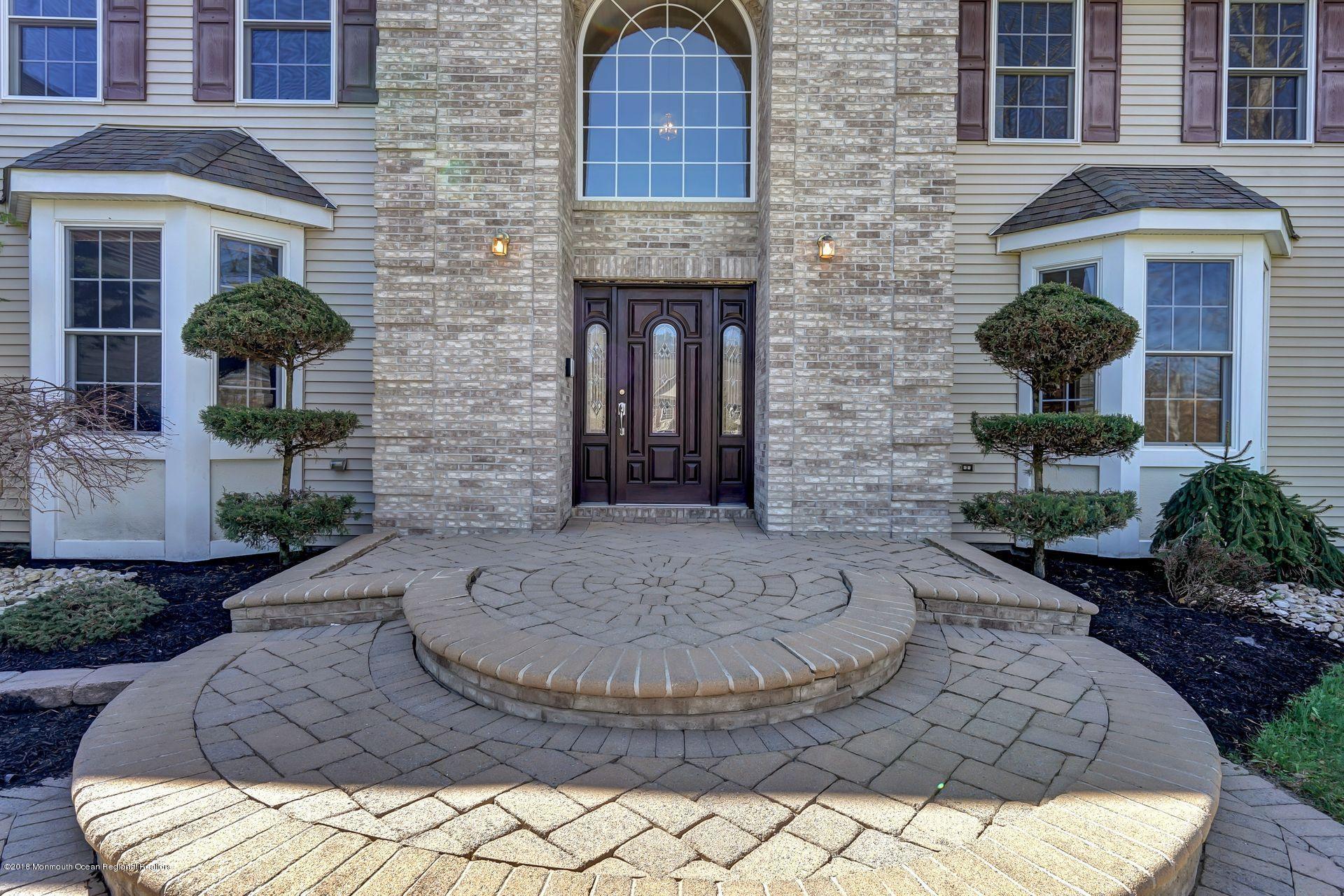 26 Conor Road Jackson, NJ 08527 - Photo 8 of 60 a view of brick house with potted plants