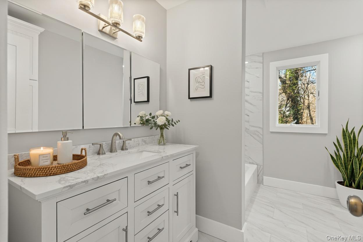 142 Crooked Hill Road Huntington Station, NY 11746 - Photo 12 of 18 Full bath featuring light marble finish floors, vanity, and bathtub / shower combination