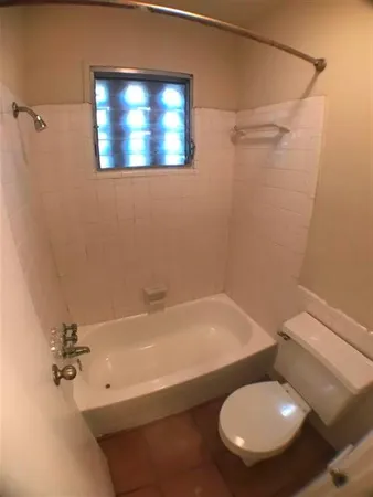a bathroom with a toilet and a bathtub