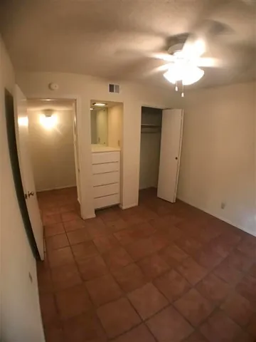 a view of hallway with stairs and wooden floor