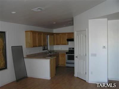 6966 South Radec Lane Tucson, AZ 85756 - Photo 2 of 8 a kitchen with stainless steel appliances granite countertop a refrigerator a stove and a sink