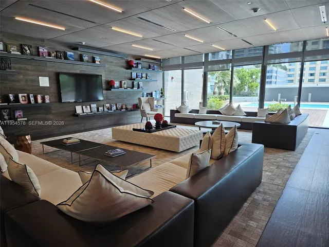 a living room with furniture and a large window