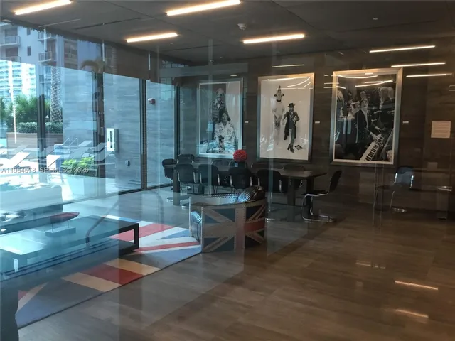 a living room with couches a dining table and chairs with outer view