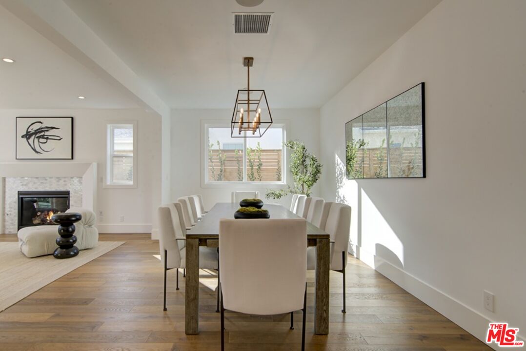 10810 Valley Spring Lane Studio City, CA 91602 - Photo 13 of 36 a dining room with furniture window and wooden floor