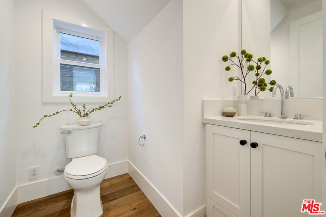 10810 Valley Spring Lane Studio City, CA 91602 - Photo 14 of 36 a bathroom with a toilet sink and mirror