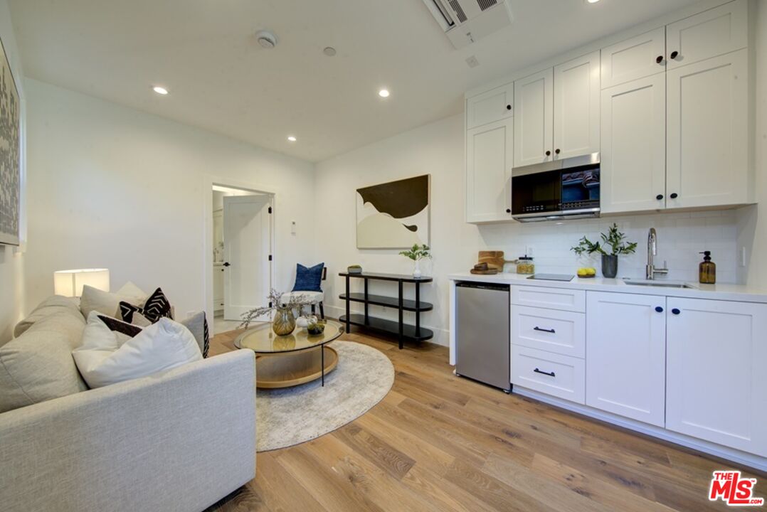 10810 Valley Spring Lane Studio City, CA 91602 - Photo 16 of 36 a living room with furniture and a wooden floor