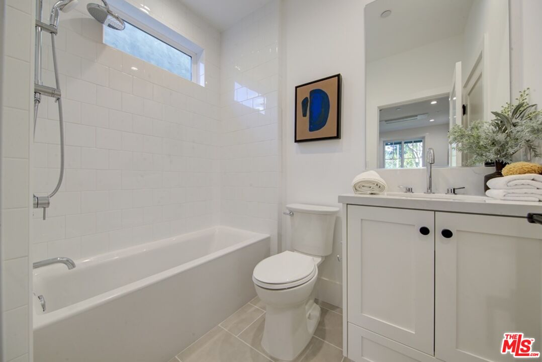 10810 Valley Spring Lane Studio City, CA 91602 - Photo 18 of 36 a bathroom with a toilet sink and shower
