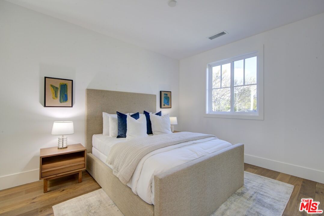 10810 Valley Spring Lane Studio City, CA 91602 - Photo 23 of 36 a bed room with a bed and a night stand