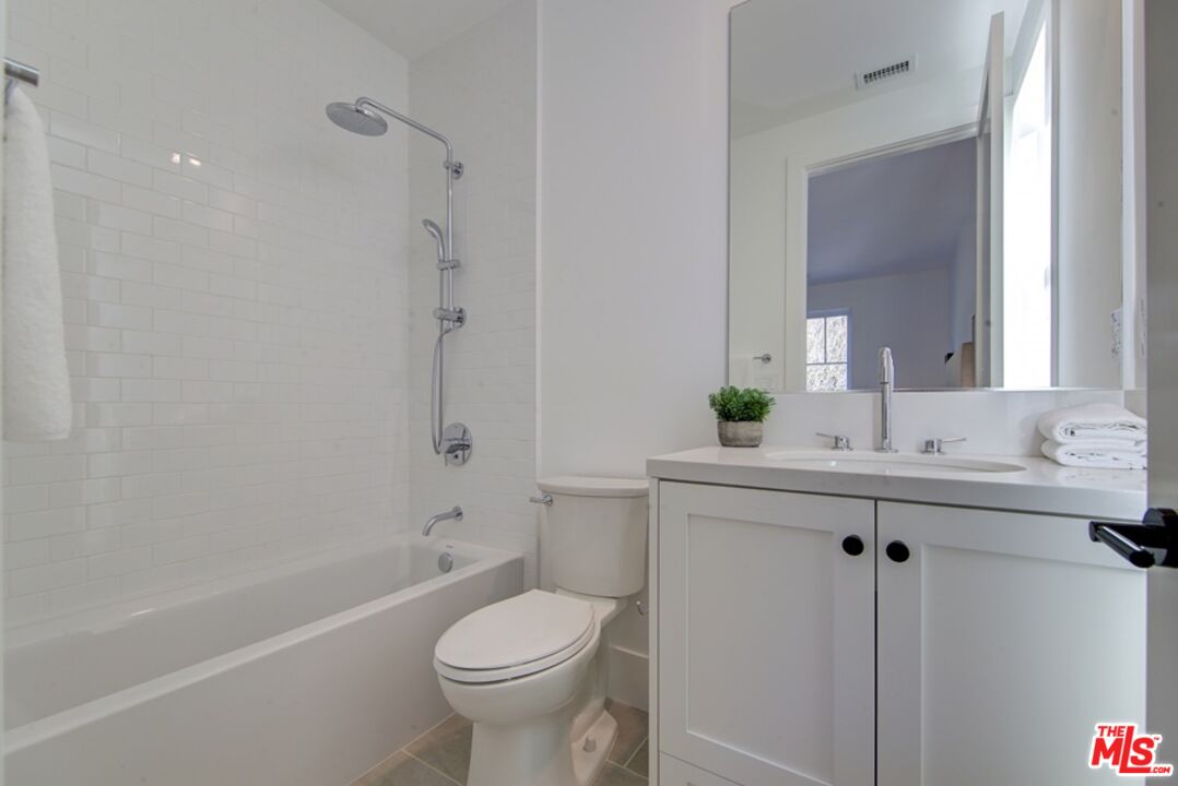 10810 Valley Spring Lane Studio City, CA 91602 - Photo 26 of 36 a bathroom with a sink toilet and shower