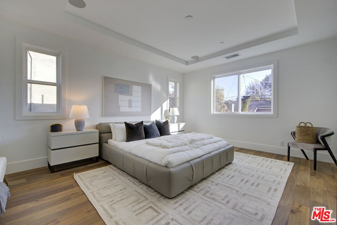 10810 Valley Spring Lane Studio City, CA 91602 - Photo 27 of 36 a bedroom with a large bed and a window