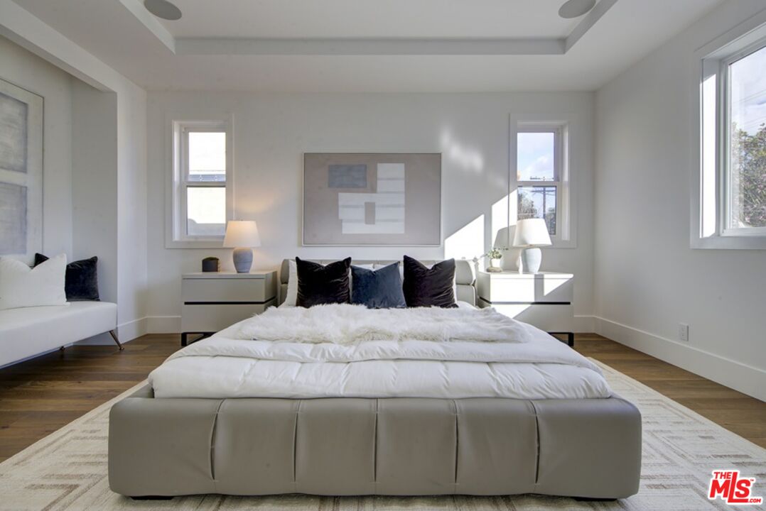 10810 Valley Spring Lane Studio City, CA 91602 - Photo 28 of 36 a bedroom with bed and window