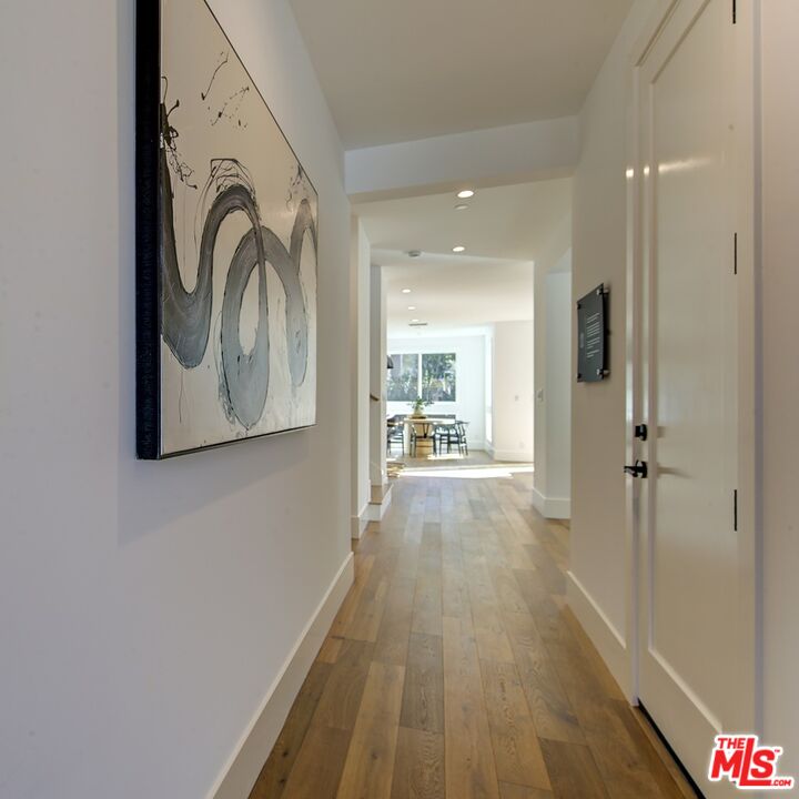 10810 Valley Spring Lane Studio City, CA 91602 - Photo 3 of 36 a view of a hallway with wooden floor and a bathroom