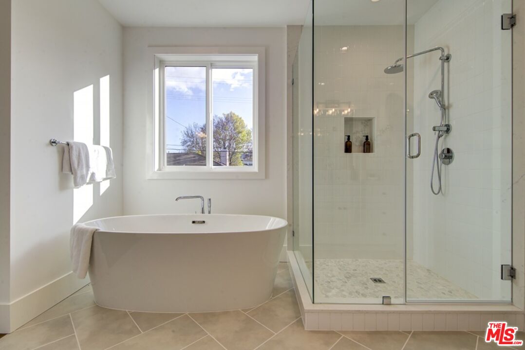 10810 Valley Spring Lane Studio City, CA 91602 - Photo 32 of 36 a bathroom with a bathtub and shower