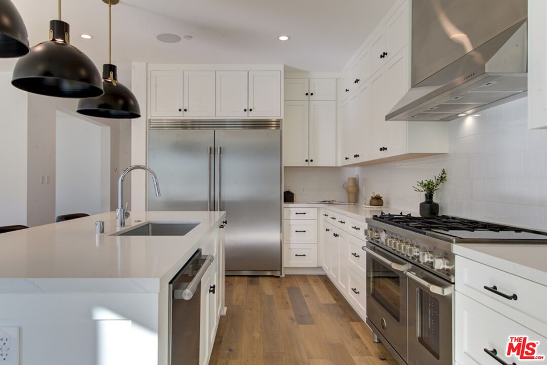 10810 Valley Spring Lane Studio City, CA 91602 - Photo 6 of 36 a kitchen with stainless steel appliances granite countertop a sink stove and refrigerator