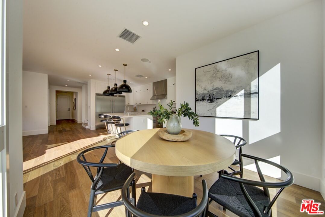 10810 Valley Spring Lane Studio City, CA 91602 - Photo 9 of 36 a dining room with furniture and wooden floor