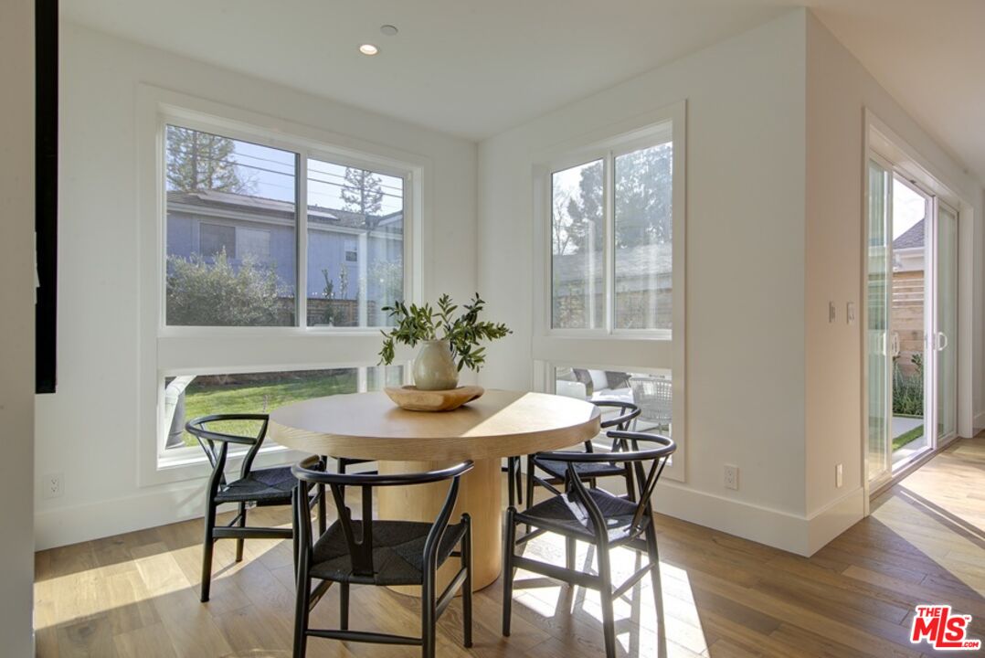 10810 Valley Spring Lane Studio City, CA 91602 - Photo 10 of 36 a view of a dining room with furniture and wooden floor