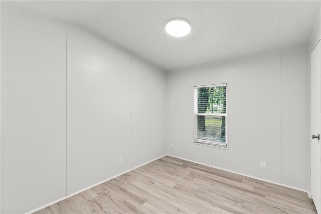 367 Box Road Gun Barrel City, TX 75156 - Photo 18 of 25 an empty room with wooden floor and windows