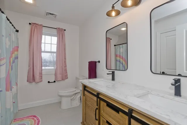 a front view of a house with yard and mountain view