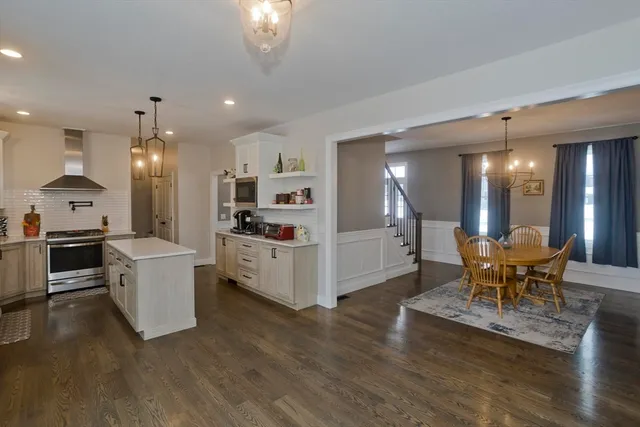 a kitchen with a sink and chairs