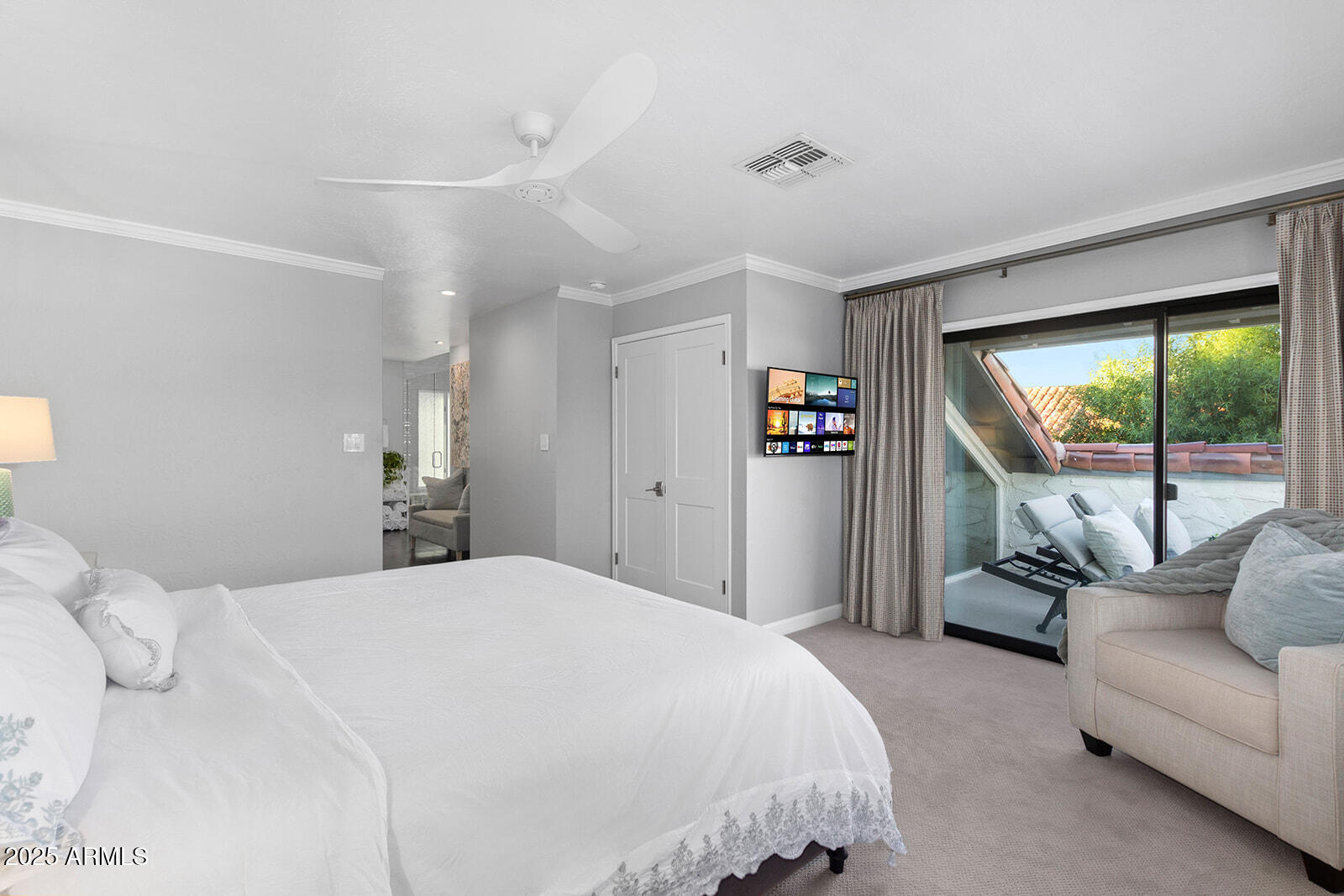 5822 North Scottsdale Road Paradise Valley, AZ 85253 - Photo 15 of 32 a bedroom with a balcony a bed and a couch