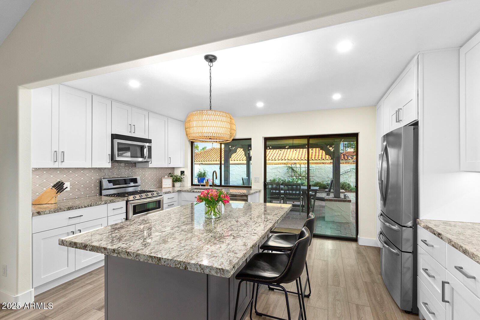 5822 North Scottsdale Road Paradise Valley, AZ 85253 - Photo 9 of 32 a kitchen with stainless steel appliances granite countertop counter space a sink cabinets and stainless steel appliances
