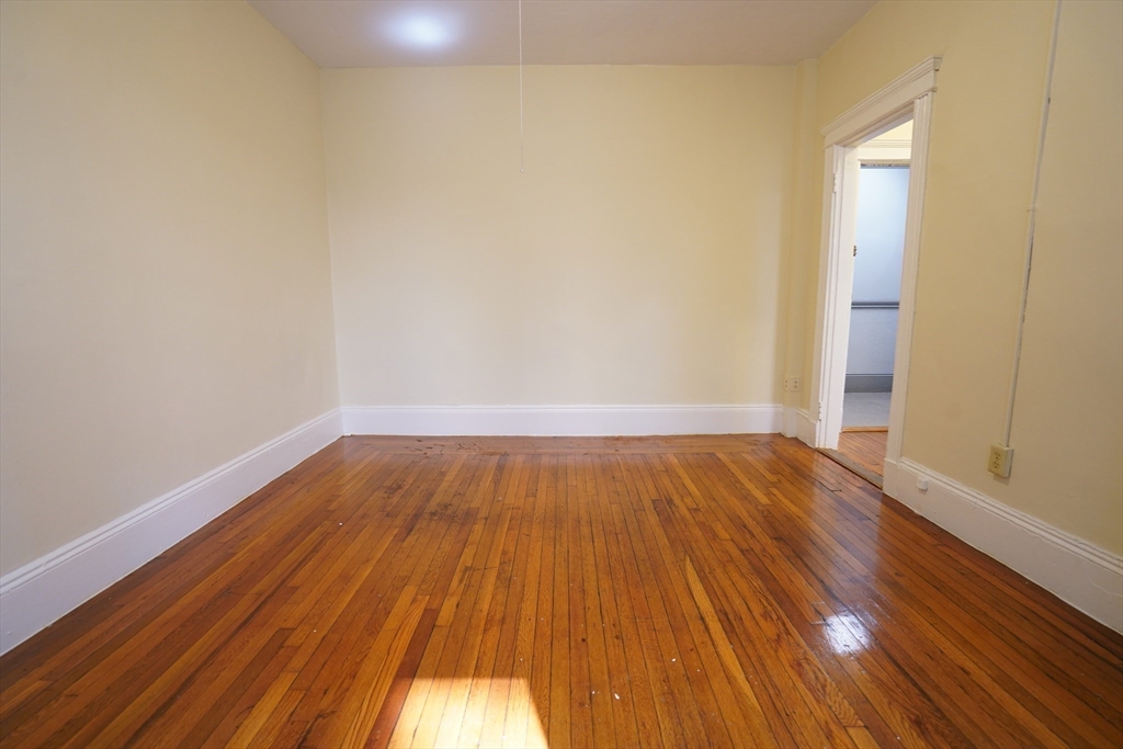 11 Royce Road, Unit 12 Boston, MA 02134 - Photo 2 of 7 a view of a room with wooden floor and brick walls