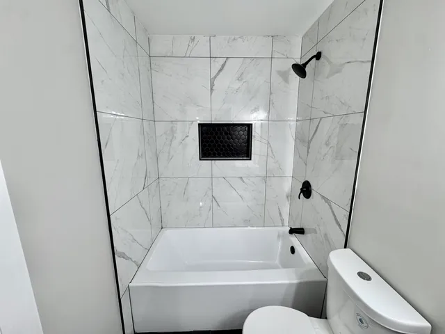 a bathroom with a bathtub and a shower