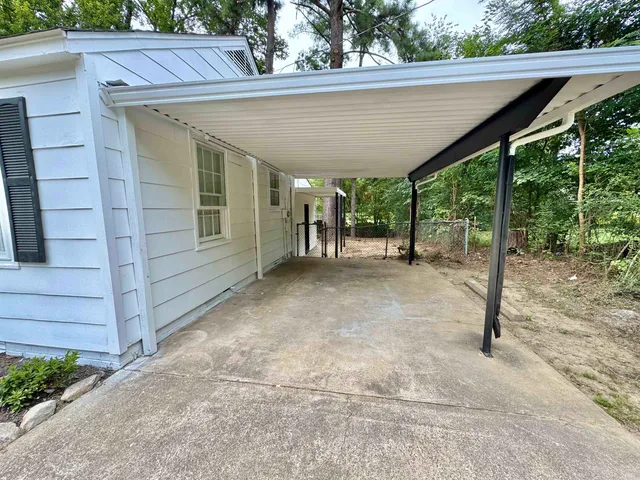a view of a patio with table and chairs with wooden floor and fence