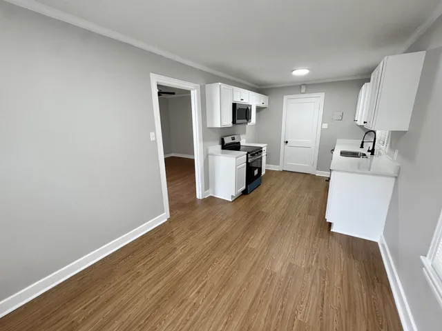 a view of kitchen with sink microwave and stove