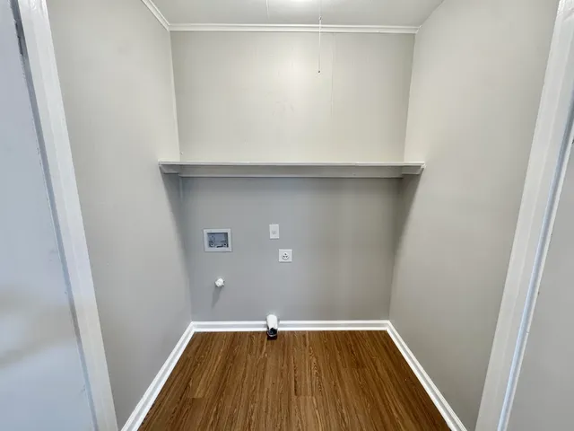 a view of storage and utility room with wooden floor