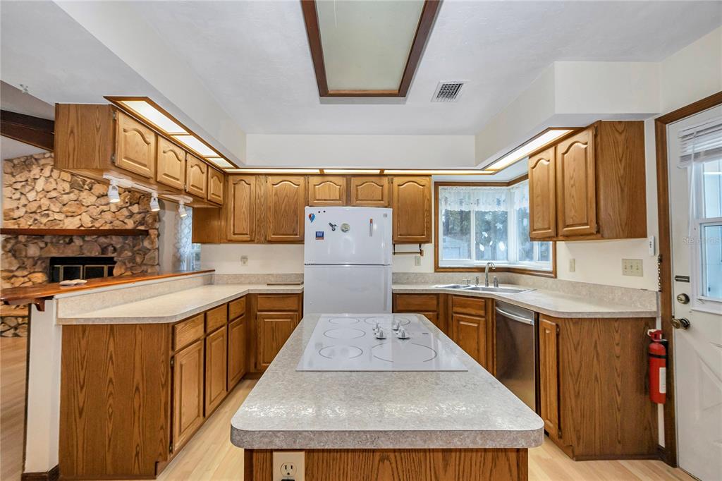 18012 Southwest 68th Loop Dunnellon, FL 34432 - Photo 14 of 60 a kitchen with stainless steel appliances granite countertop a sink stove and refrigerator
