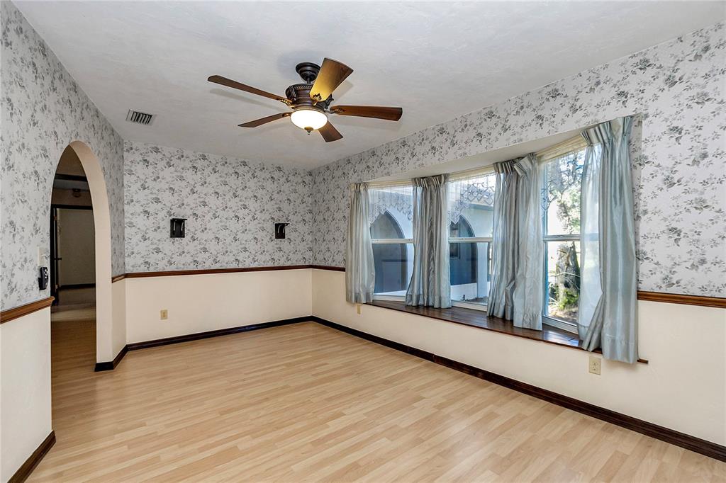 18012 Southwest 68th Loop Dunnellon, FL 34432 - Photo 20 of 60 a living room with a large window and a ceiling fan