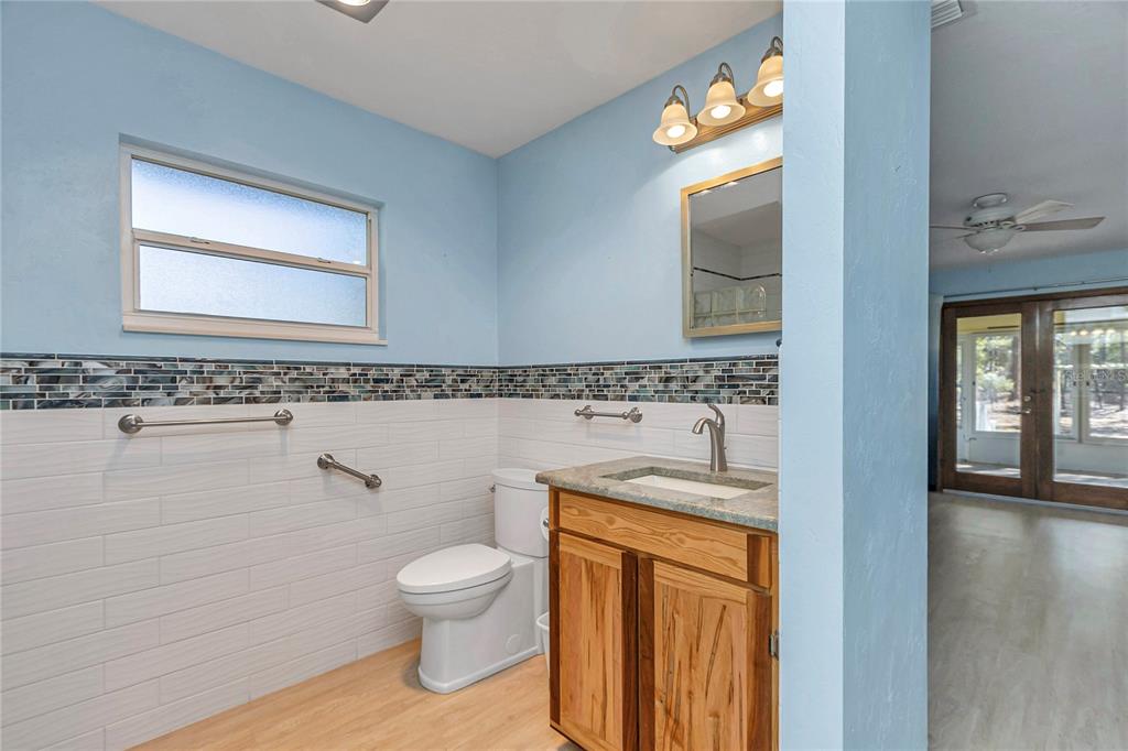 18012 Southwest 68th Loop Dunnellon, FL 34432 - Photo 25 of 60 a bathroom with a granite countertop toilet a sink and mirror