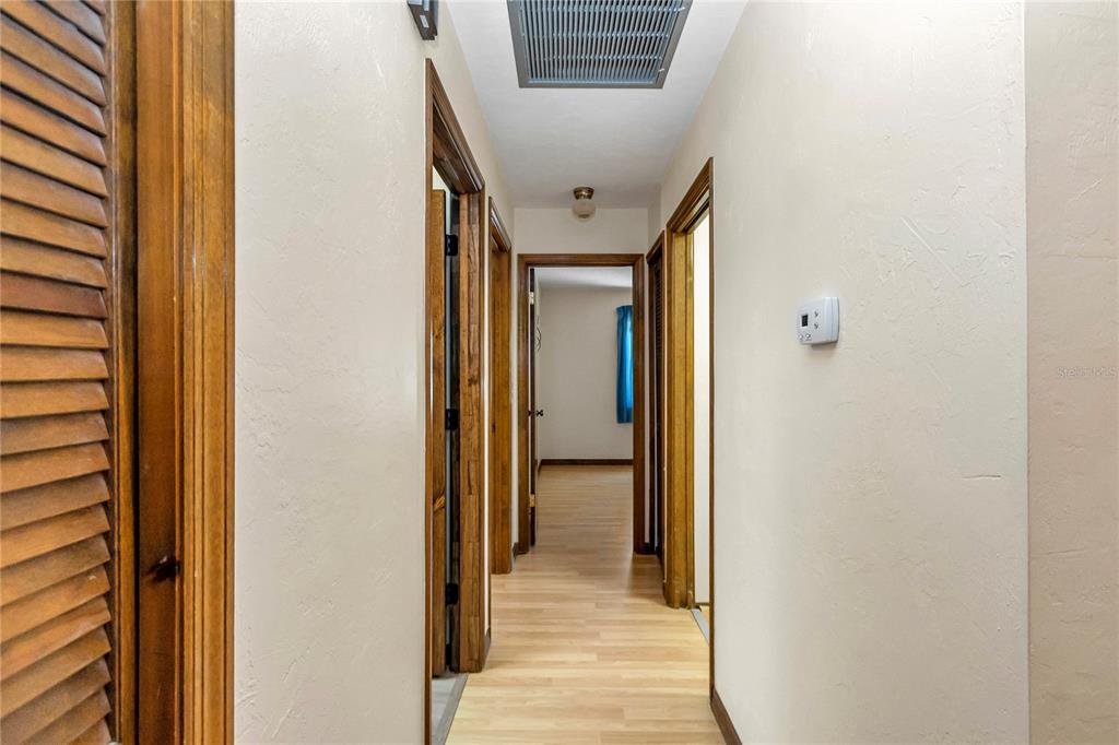 18012 Southwest 68th Loop Dunnellon, FL 34432 - Photo 30 of 60 a view of a hallway with wooden floor and a bathroom