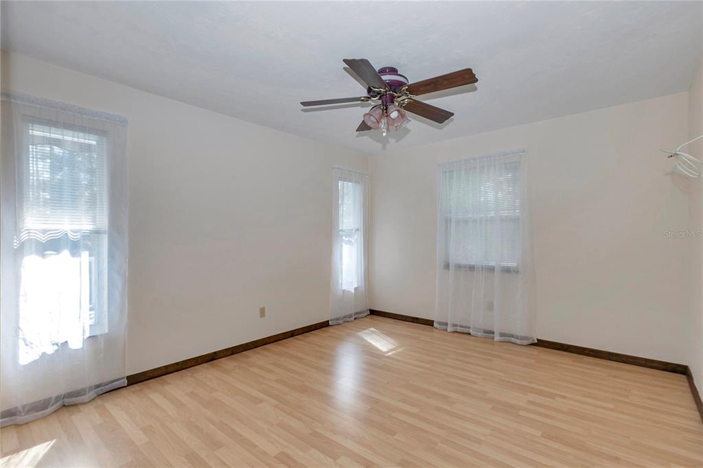 18012 Southwest 68th Loop Dunnellon, FL 34432 - Photo 31 of 60 a view of an empty room with wooden floor and a window