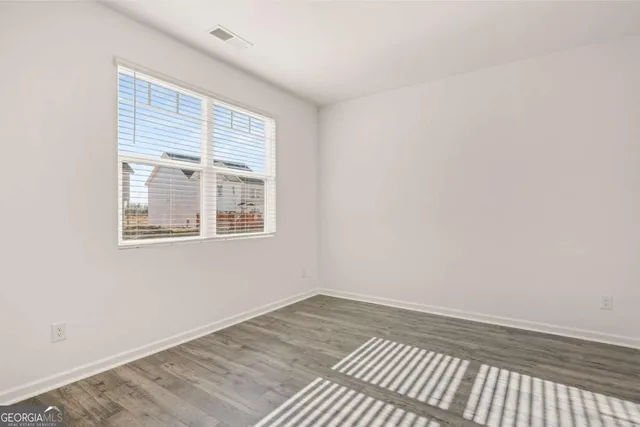 a view of an empty room and wooden floor