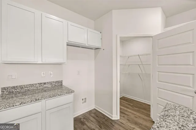 a view of a kitchen with wooden floor and electronic appliances