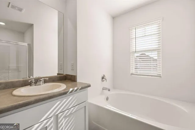 a bathroom with a glass shower door