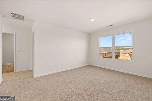 an empty room with a empty space and windows