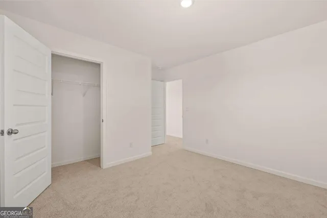 a view of a room with wooden floor and closet