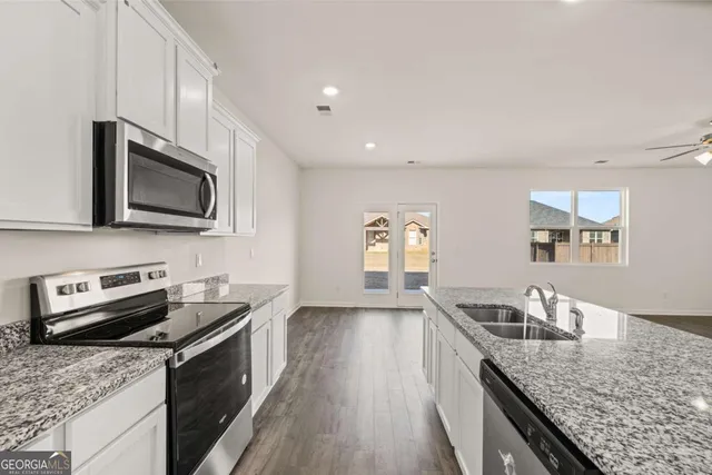 an empty room with windows and closet