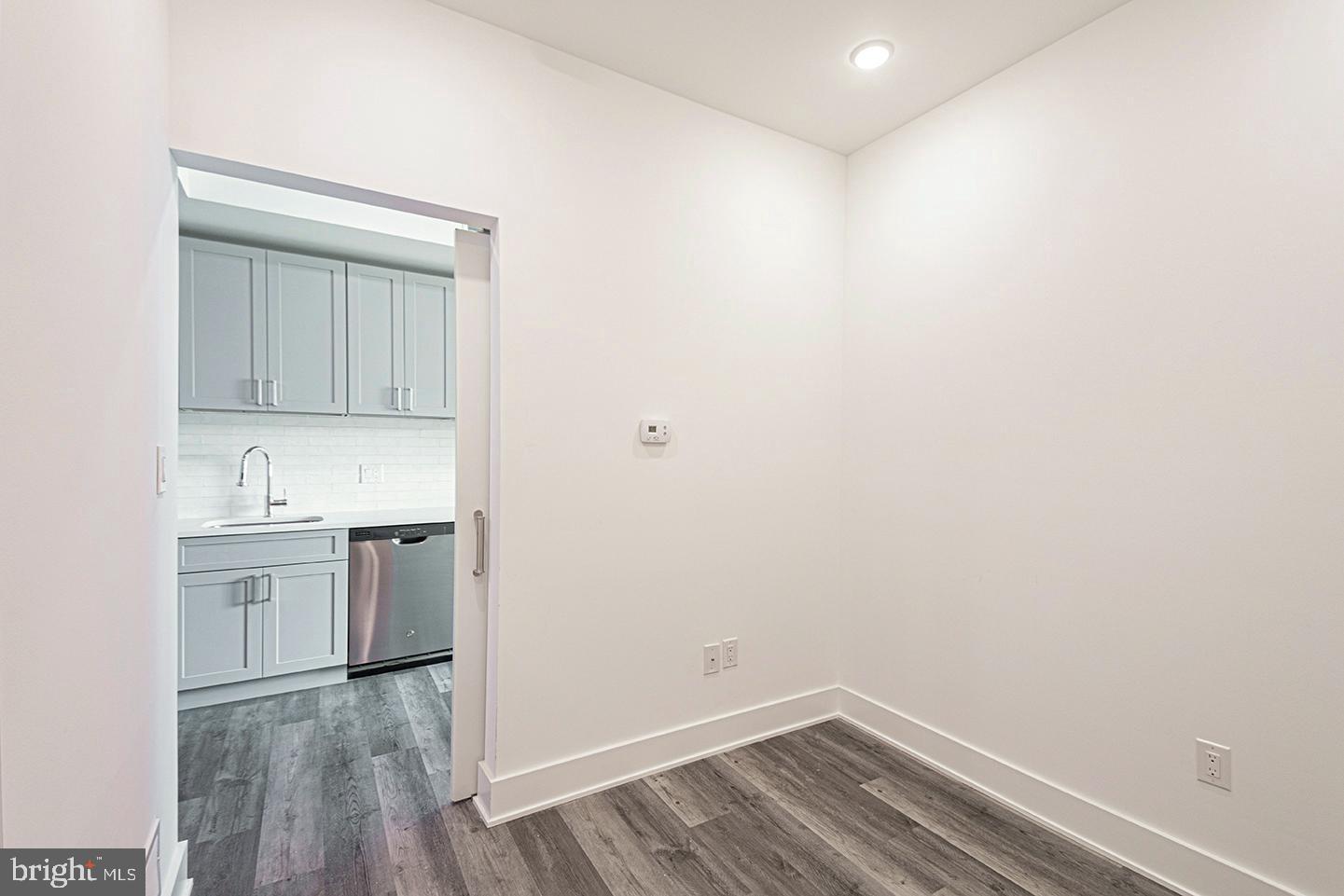 1245 Ridge Avenue, Unit 103 Philadelphia, PA 19123 - Photo 11 of 18 a room with a sink cabinets and wooden floor