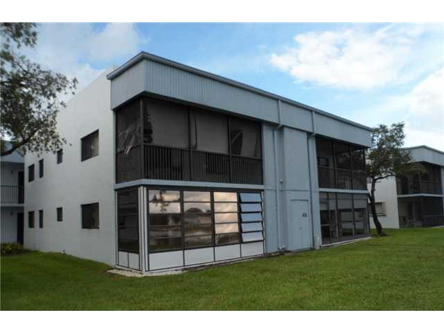 9920 Northwest 68th Place, Unit 210 Tamarac, FL 33321 - Photo 1 of 12 a view of outdoor space yard and deck