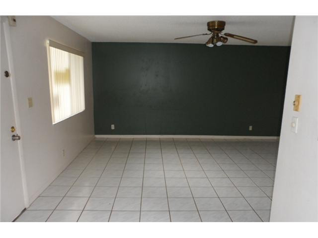 9920 Northwest 68th Place, Unit 210 Tamarac, FL 33321 - Photo 4 of 12 a view of an empty room and window