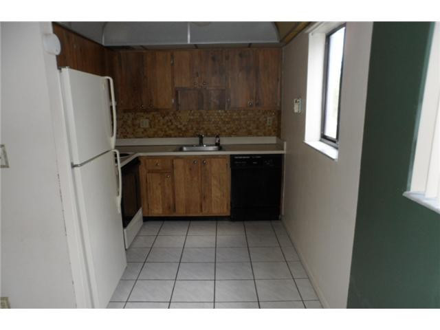 9920 Northwest 68th Place, Unit 210 Tamarac, FL 33321 - Photo 5 of 12 a kitchen with a refrigerator and window