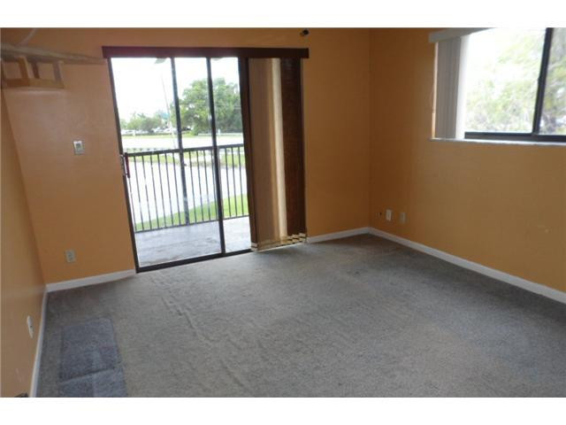 9920 Northwest 68th Place, Unit 210 Tamarac, FL 33321 - Photo 7 of 12 a view of an empty room with a window