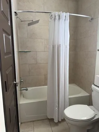 a bathroom with a toilet and a shower