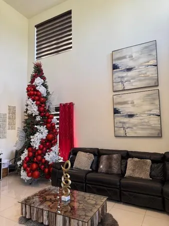 a living room with furniture and flowers