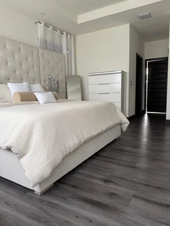 a large white bed in a white room