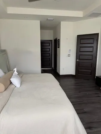 a bedroom with a bed and wooden floor